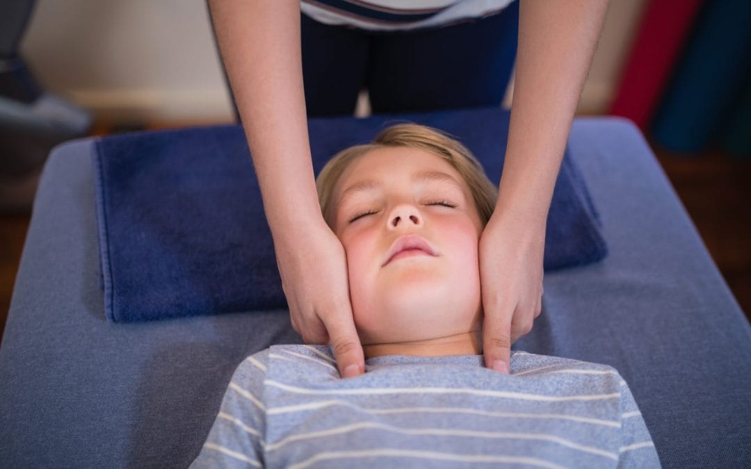 high-angle-view-of-boy-receiving-neck-massage