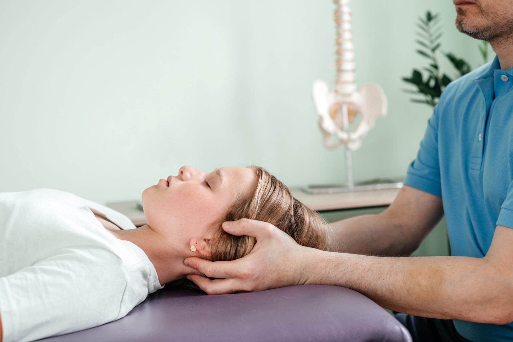 a-girl-receiving-cst-treatment-by-osteopath-practi